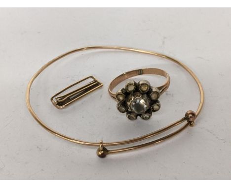 A yellow metal bangle together a yellow metal clip and yellow and white metal daisy ring, 7.5gLocation: CAB5 