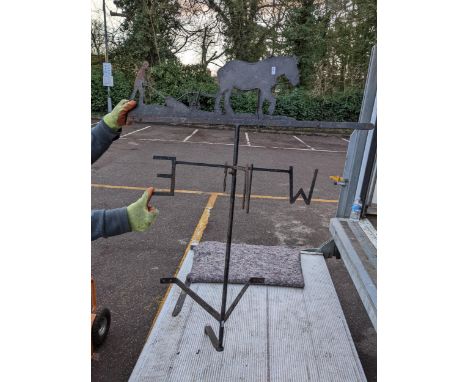 A large cast iron weather vane with horse and farmer decoration to the top Location: 