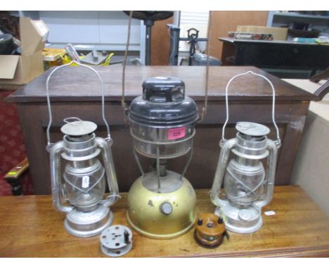 An Allcock &amp; Co wooden fishing reel, an aluminium reel, a Tilley lamp, and two Anchor lamps Location: 