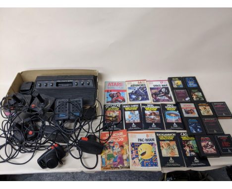 Atari-Wong Ltd video computer system, model No CX-2600U with various game controllers, games and associated instruction leafl