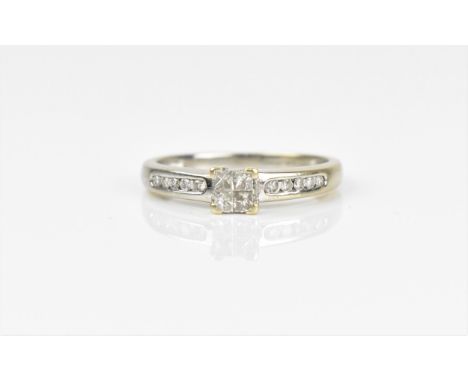An 18ct white gold and diamond engagement ring, with central four section diamond flanked with a row of five round brilliant 