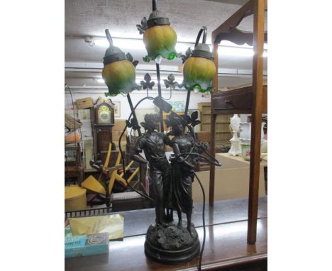 A modern composition bronzed resin table lamp in the form of a courting couple holding flowers, mounted on a faux marble circ