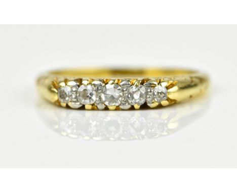 An 18ct yellow gold five stone diamond ring, with graduated stones to the centre, all claw set in carved gypsy style mount, d