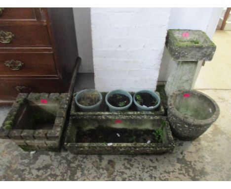 A group of weathered garden concrete planters and a bird bath on tapering column and square base, to include a pair of trough
