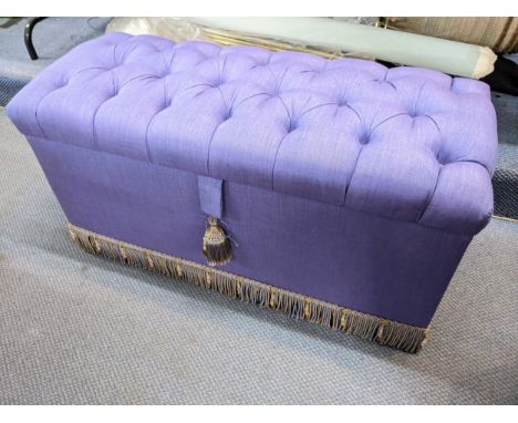 A lilac button upholstered ottoman with a fringed border to the base, 48cm h x 95cm wLocation: 