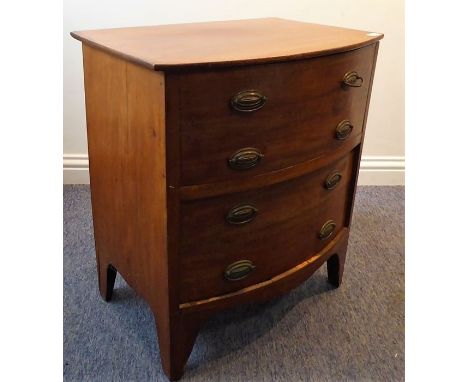 An early 19th century bow-fronted mahogany commode; hinged top and with large, full-width bow-fronted drawer below, shaped ap