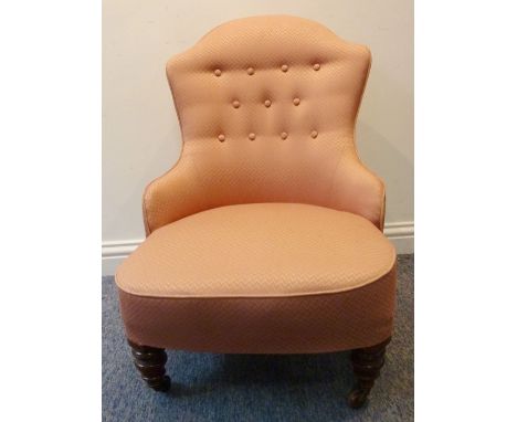 A late 19th century&nbsp;nursing-style low chair;&nbsp;button-back upholstered and with turned front legs terminating in cast