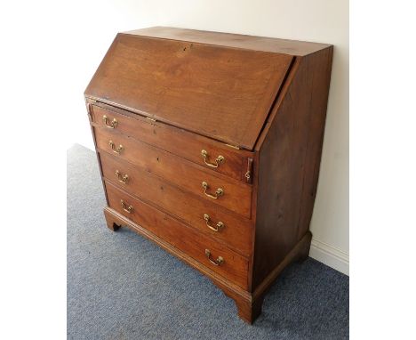A late 18th century mahogany writing bureau; the cleated fall opening to reveal fitted interior with central cupboard door fl
