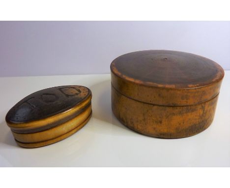 Two 19th century snuff boxes (the oval horn pocket box 5.4cm, and the circular fruitwood table snuff box 7.8cm in diameter)