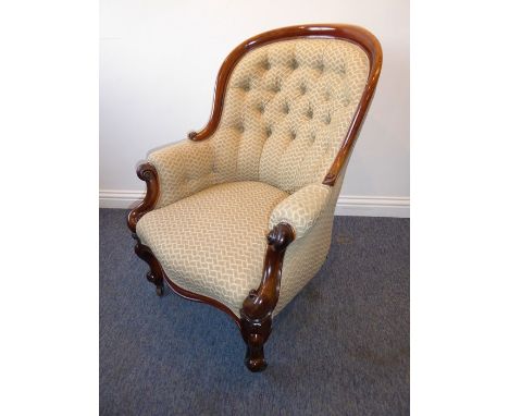 A good mid-19th century button-back-upholstered and mahogany-framed armchair; scrolling arms, serpentine front rail and bulbo