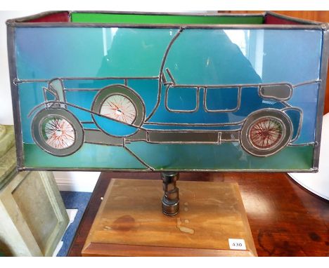 An unusual table lamp modelled from racing car parts and decorated with an open-top 1920s-style vehicle (shade 43cm widest x 