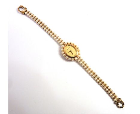 A 9-carat yellow-gold and cultured-pearl wristwatch by Bueche Girod, the plain oval dial signed 'Bueche-Girod' and 'Swiss' to