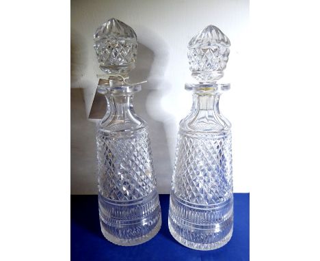 A pair of finely hand-cut early 20th century heavy crystal decanters of conical form; small extremities to top of lip and one