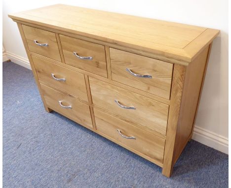A modern light-oak side chest; three small top drawers and sets of two half-width drawers below, raised on stile feet (120cmx