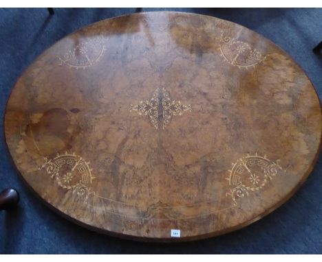 A very fine mid-19th century walnut and marquetry oval-topped tilt-top loo table; the quarter-veneered moulded top with strin