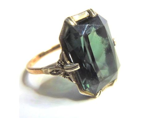 An Art Deco style gold ring set with a large green stone, possibly a green garnet (not tested) PLEASE NOTE - this is not, as 