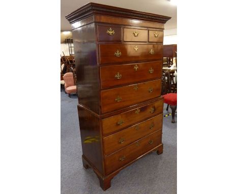 A late 18th century mahogany chest-on-chest; the dental cornice over an arrangement of various graduated drawers, raised on b
