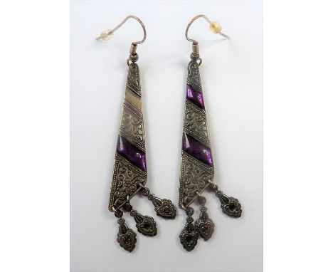 A pair of unusual elongated triangular silver earrings engraved with foliate designs and mounted with a mauve-coloured enamel