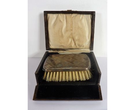A small silver-mounted brush with engine-turned decoration;&nbsp;assayed Birmingham 1926&nbsp;(damage to the case)