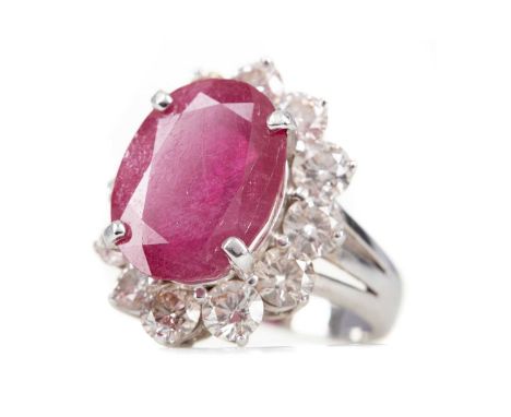 RUBY AND DIAMOND RING,set with an oval ruby of approximately 8.67 carats within a halo of round brilliant cut diamonds totall