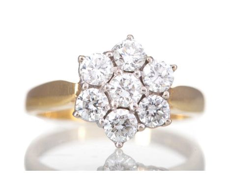 DIAMOND DAISY CLUSTER RING,set with round brilliant cut diamonds totalling approximately 0.71 carats, in eighteen carat gold,