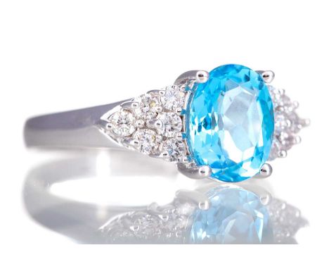 CERTIFICATED TOPAZ AND DIAMOND RING,set with an oval topaz of approximately 3.10 carats, flanked by round brilliant cut diamo