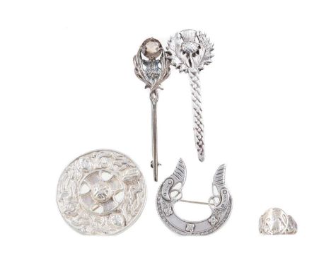 COLLECTION OF SCOTTISH SILVER,including four brooches and a ring (5)All clasps in working order.&nbsp;Shield brooch - 44mm di