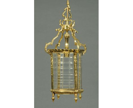 An Edwardian cylindrical glass and brass hall lantern.  Height to top of hanger 48 cm. 