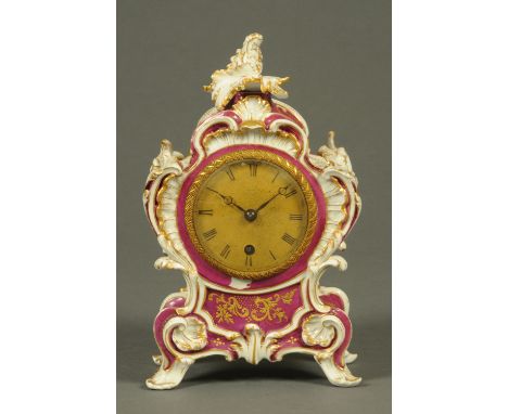 A French porcelain mantle clock, with scrolling Rococo frame, gilt dial, single-train movement.  Height 25 cm.