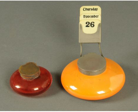 A Moorcroft orange lustre glazed inkwell and calendar stand, impressed "Moorcroft Burslem", diameter 11.5 cm, and a cranberry