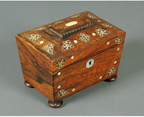 A Regency rosewood inlaid mother of pearl tea caddy, sarcophagus form, raised on short bun feet.  Width 19 cm. 