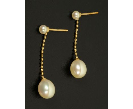 A pair of pearl earrings, with small pearl suspending a chain to larger pearl, butterfly stamped "18 k".