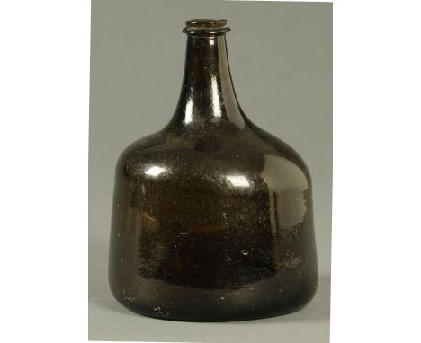 An 18th century green glass bottle, club shaped.  Height 18 cm.  CONDITION REPORT: Generally very good condition, with no sig