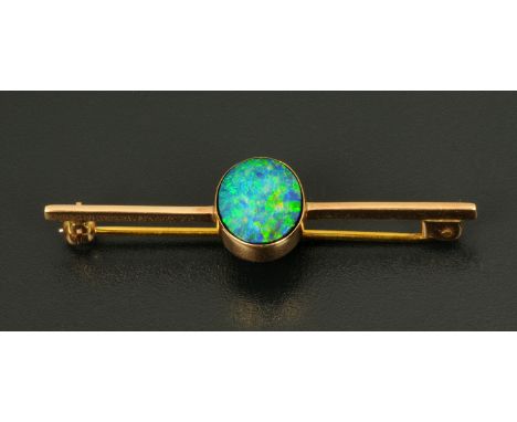 A 9 ct gold bar brooch with black opal doublet.