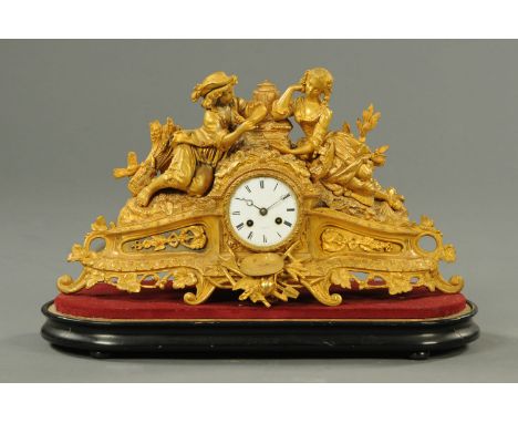A spelter figural mantle clock, late 19th century, with two-train movement and raised on a wooden base.  Clock height 30 cm, 