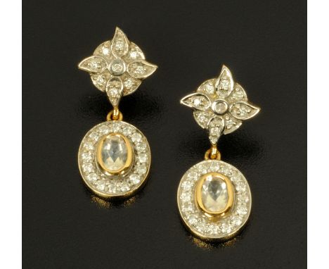 A pair of 18 ct gold cluster earrings, the centre white stone with a surround of small diamonds with further diamonds to each