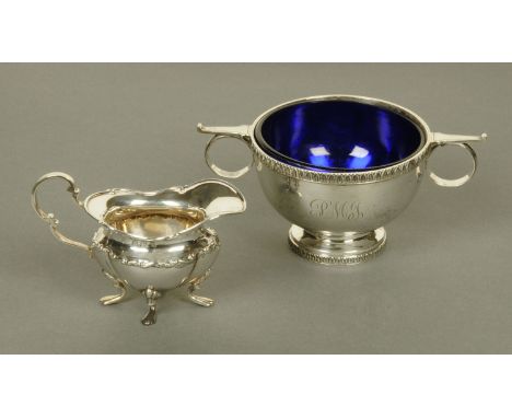 A silver two handled sugar basin, Walker & Hall, Sheffield 1930, with blue glass liner, 343 grams gross, diameter 10 cm, and 