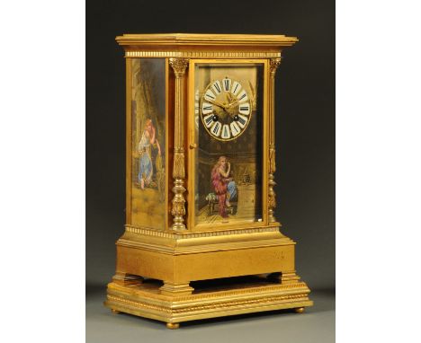 A late 19th century French gilt brass mantle clock, with porcelain panels depicting draped female figures in an Egyptian styl