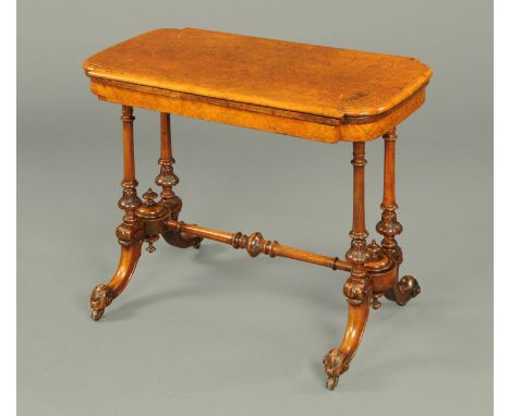 A Victorian walnut turnover top card table, boxwood strung, with green baize lined playing surface and raised on turned suppo