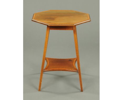 An Edwardian inlaid mahogany octagonal occasional table, crossbanded in satinwood, with four tapered legs united by a raised 