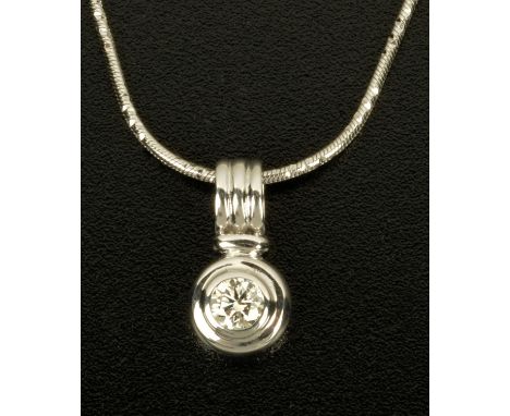 An 18 ct white gold pendant, on chain, with rubover set diamond weighing .35 carats.