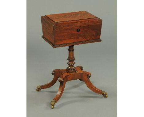 A Regency mahogany worktable, with caddy top to open interior, with turned column and four downswept legs terminating in bras