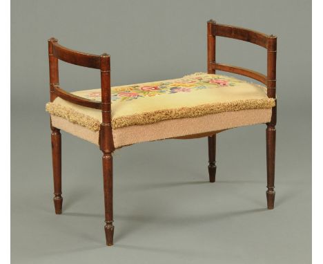 A Regency mahogany dressing stool, with woolwork tapestry upholstered top, bowed sides and raised on turned legs.  Width 84 c