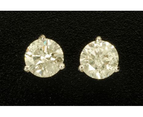 A pair of 18 ct white gold three claw stud earrings, set with diamonds weighing approximately 3.09 carats. CONDITION REPORT: 