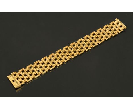 A 9 ct gold four bar gate bracelet, with bark finish, Birmingham 1971, C.G. & S., 41.8 grams.  Length 182.5 mm, width 22.6 mm