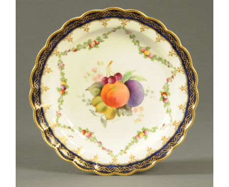A Royal Worcester shallow dish, painted with fruit to the centre and signed "Phillips", with gilt and blue border.  Diameter 