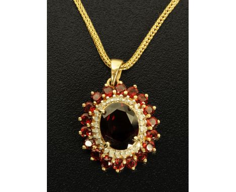 A 9 ct gold garnet and diamond pendant, with 9 ct gold chain.  Pendant size excluding hanger 20 mm x 14 mm. 