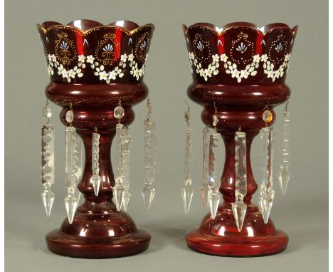 A pair of Victorian cranberry glass lustres, with faceted clear glass drops.  Height 32 cm.  CONDITION REPORT: The first lust