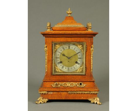 An oak cased mantle clock, with brass decoration and two-train striking movement.  Height 47 cm. 