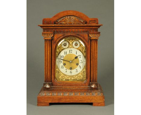 An Edwardian oak cased mantle clock, with three-train movement striking on a gong and four gongs, the movement by Junghans.  